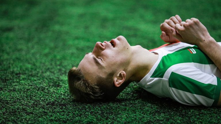 Footballer taking a short recovery nap in a quiet training facility